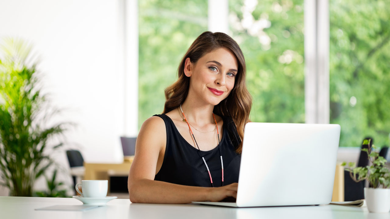 Happy woman on her desk